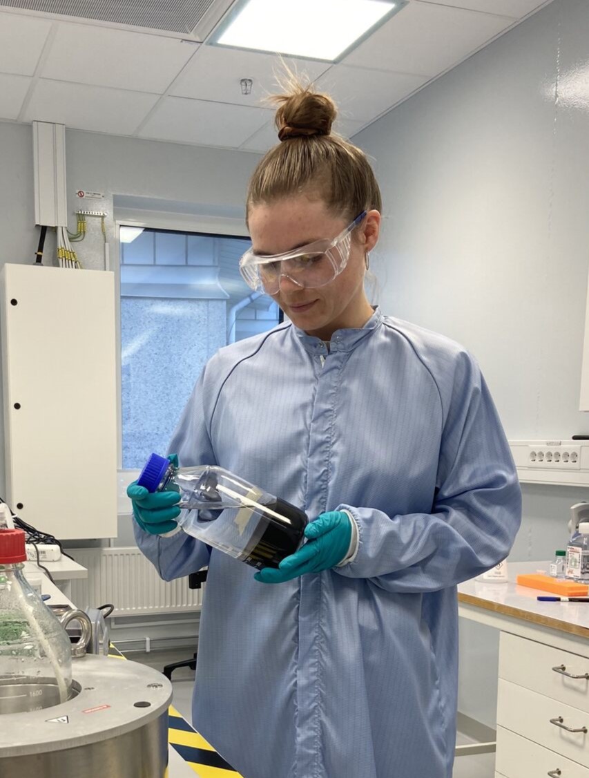 Anna Bergan Dahl in a lab coat and glasses working at the Testa Center